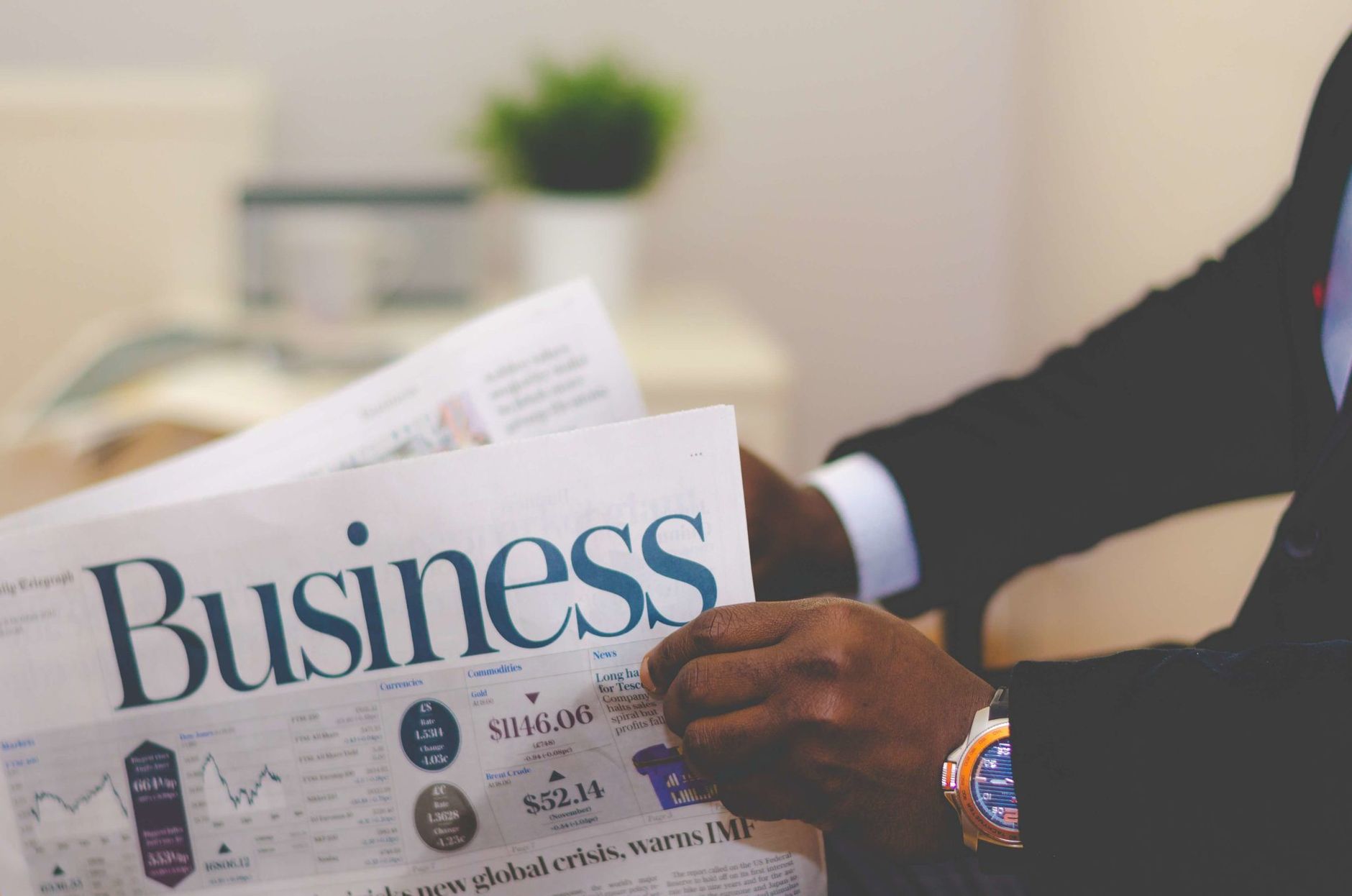 Close-up of a businessman reading a newspaper indoors, focusing on business headlines. — Achieving a Swift Sale for Your Rive