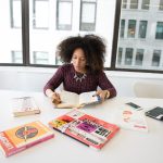 A focused woman working in an office environment, studying and reading research material. — Expert Window Installation for Ho