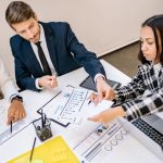Business professionals engaging in a collaborative meeting with charts and documents. — Local Restaurant: A Great Place for M