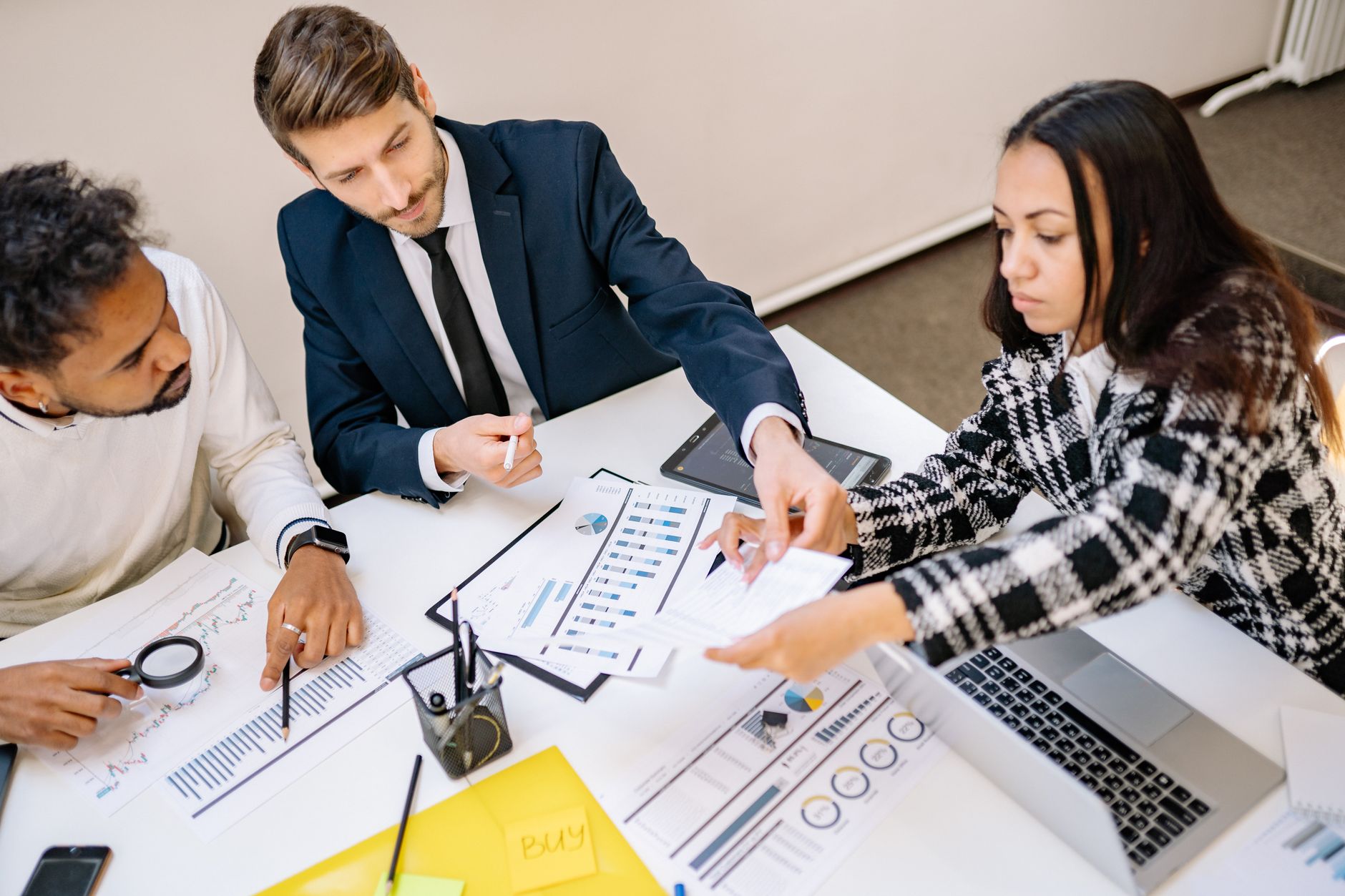 Business professionals engaging in a collaborative meeting with charts and documents. — Local Restaurant: A Great Place for M