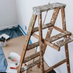 A messy stepladder and painting tools set up for a home interior renovation project. — Maximize Your Outdoor Space with These