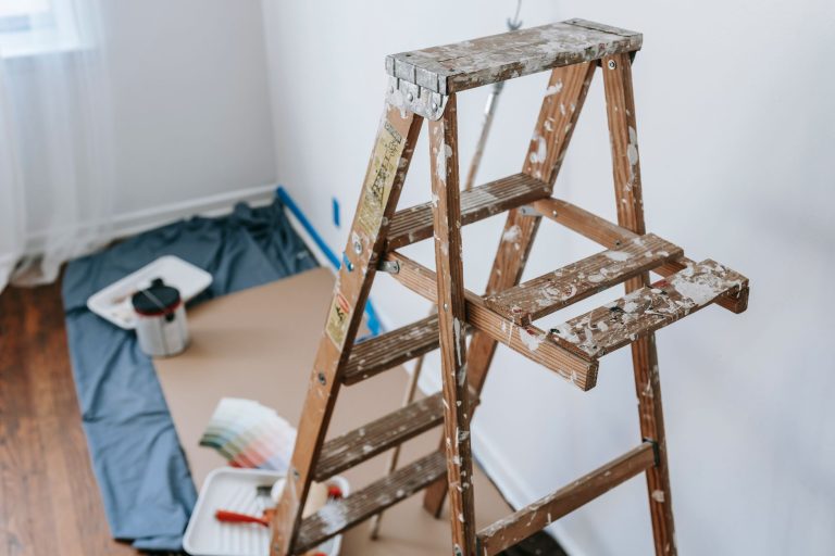 A messy stepladder and painting tools set up for a home interior renovation project. — Maximize Your Outdoor Space with These