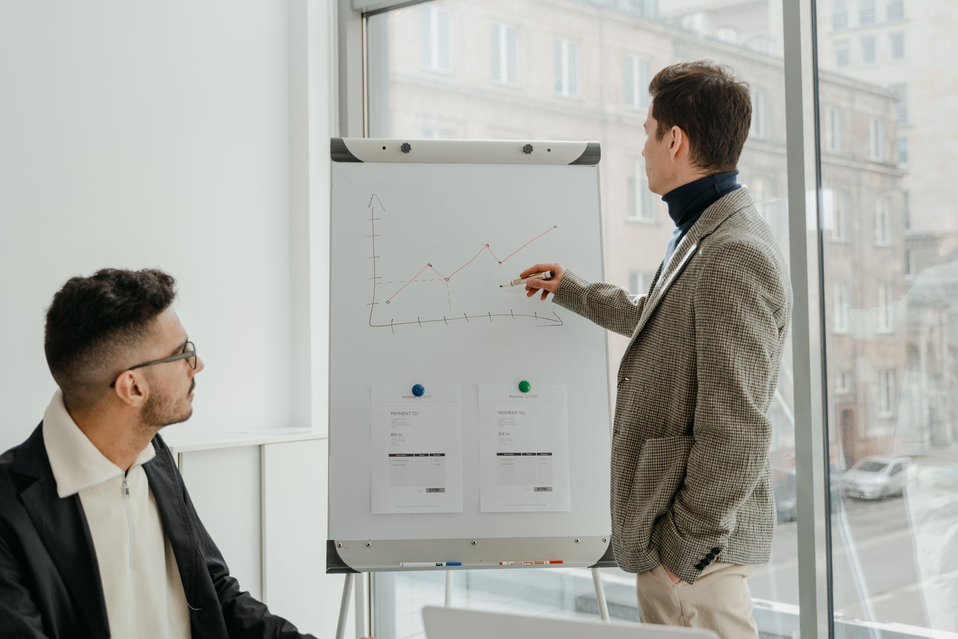 Two professionals examining graphs during an office presentation. — Mental Rejuvenation: How Wellness Retreats in Costa Rica