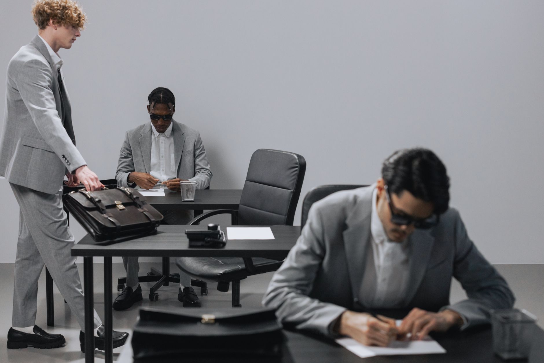 Business office with diverse employees in gray suits working at desks in an indoor setting. — The Value of Locksmith Services